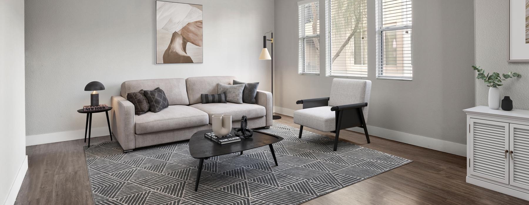 a living room with a rug and a fan